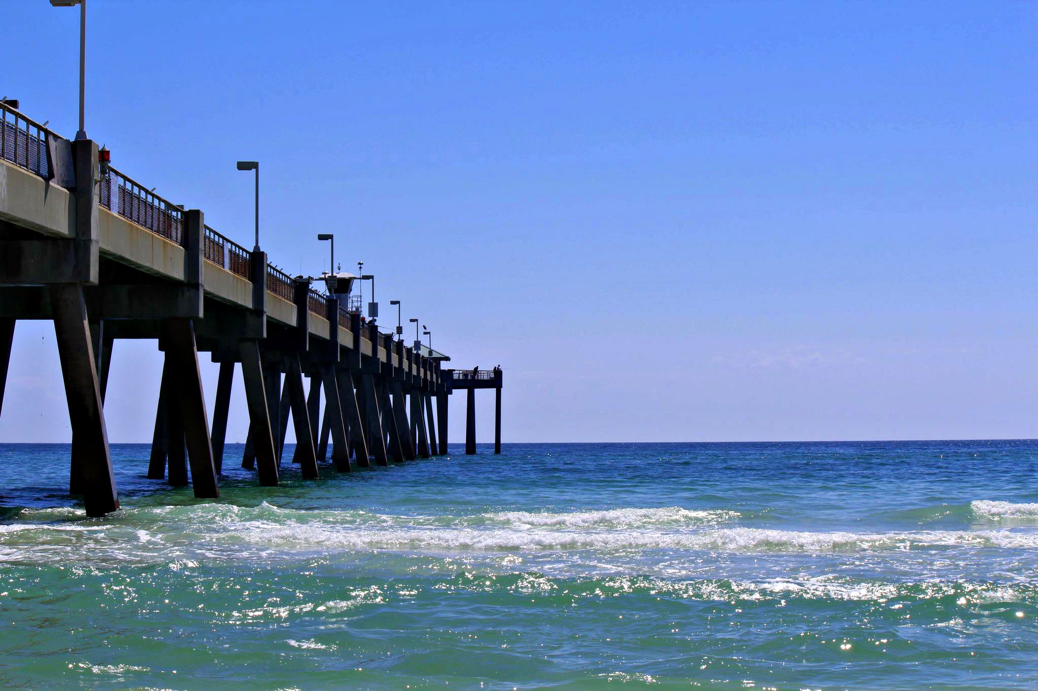 Gulf waves lap against the Okaloosa Island Fishing Pier in Fort Walton Beach