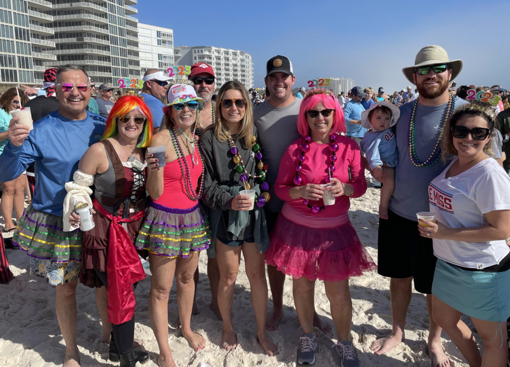 Birmingham-area resident Sheri Corey and her family of 10 pose for a photo on the beach during the 2023 Flora-Bama Polar Bear Dip.