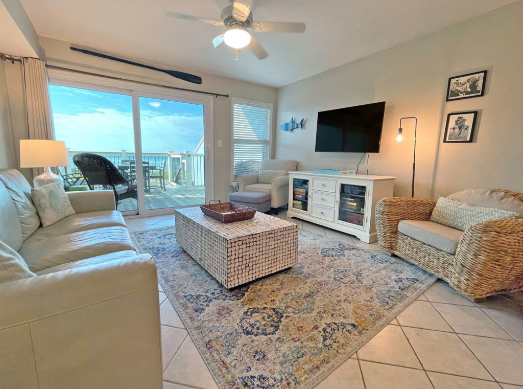San De Luna condo 27's living room with sliding doors providing a view of the Gulf of Mexico.